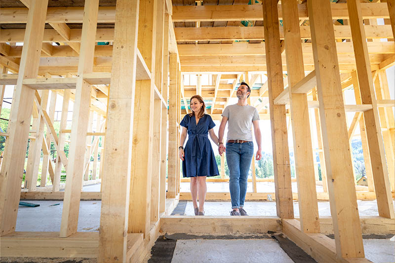 couple walking through new construction home